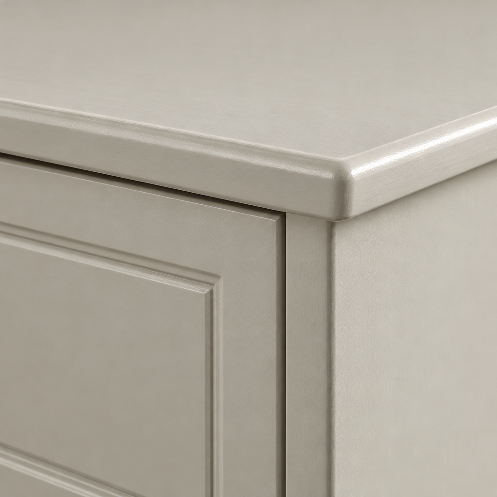 Close-up of the Aurora 6 drawer chest top corner and overhang in a greige painted finish