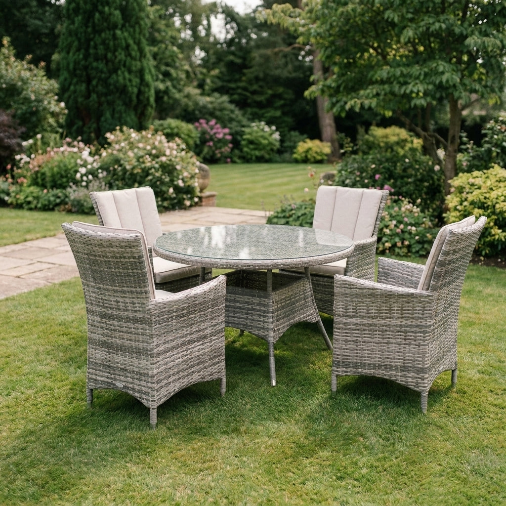 Madrid Garden Set in grey rattan with a round glass topped table and four armchairs on a lawn