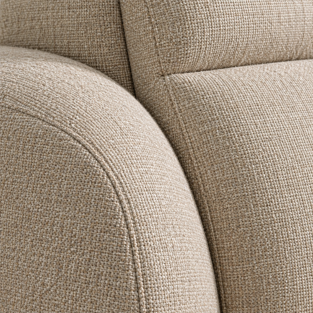 Close detail of the Clarice sofa where the rolled arm meets the high back, showing the beige woven fabric